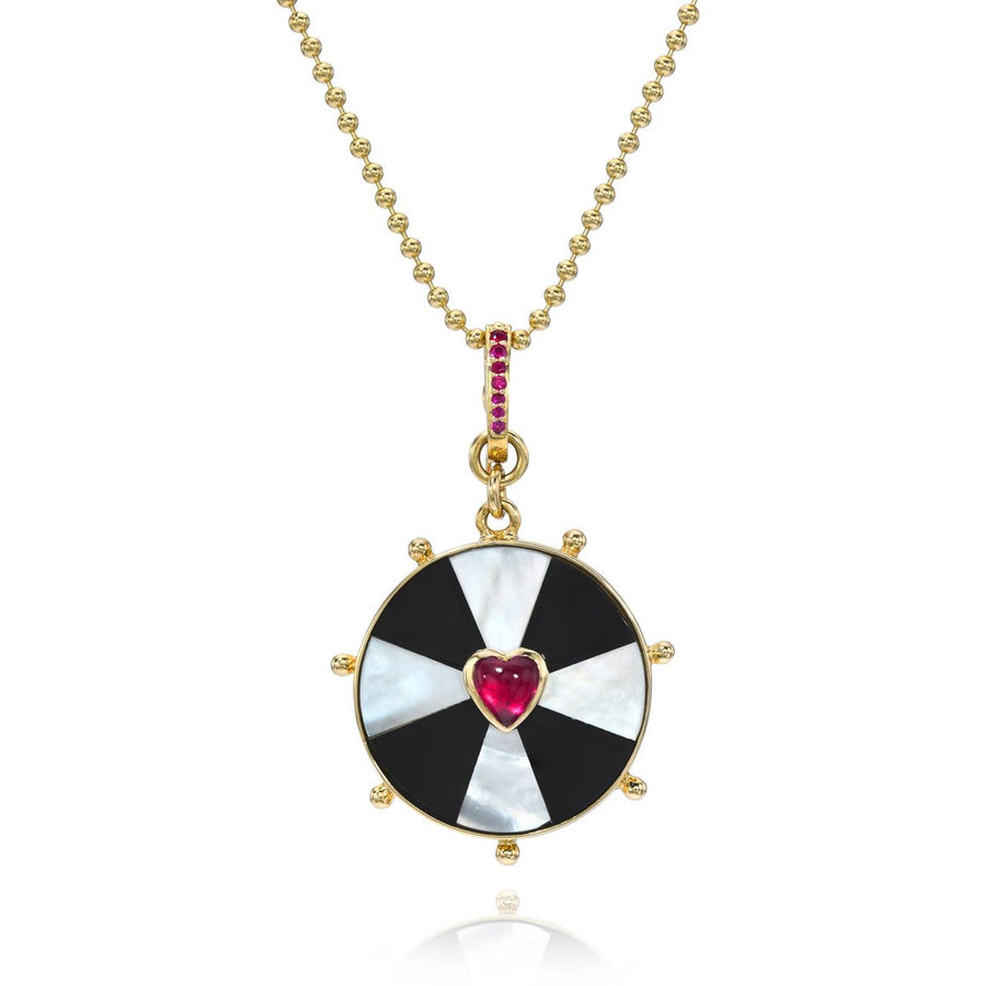Rachel Quinn Jewelry circle black and white bullseye necklace with heart in center on gold chain.