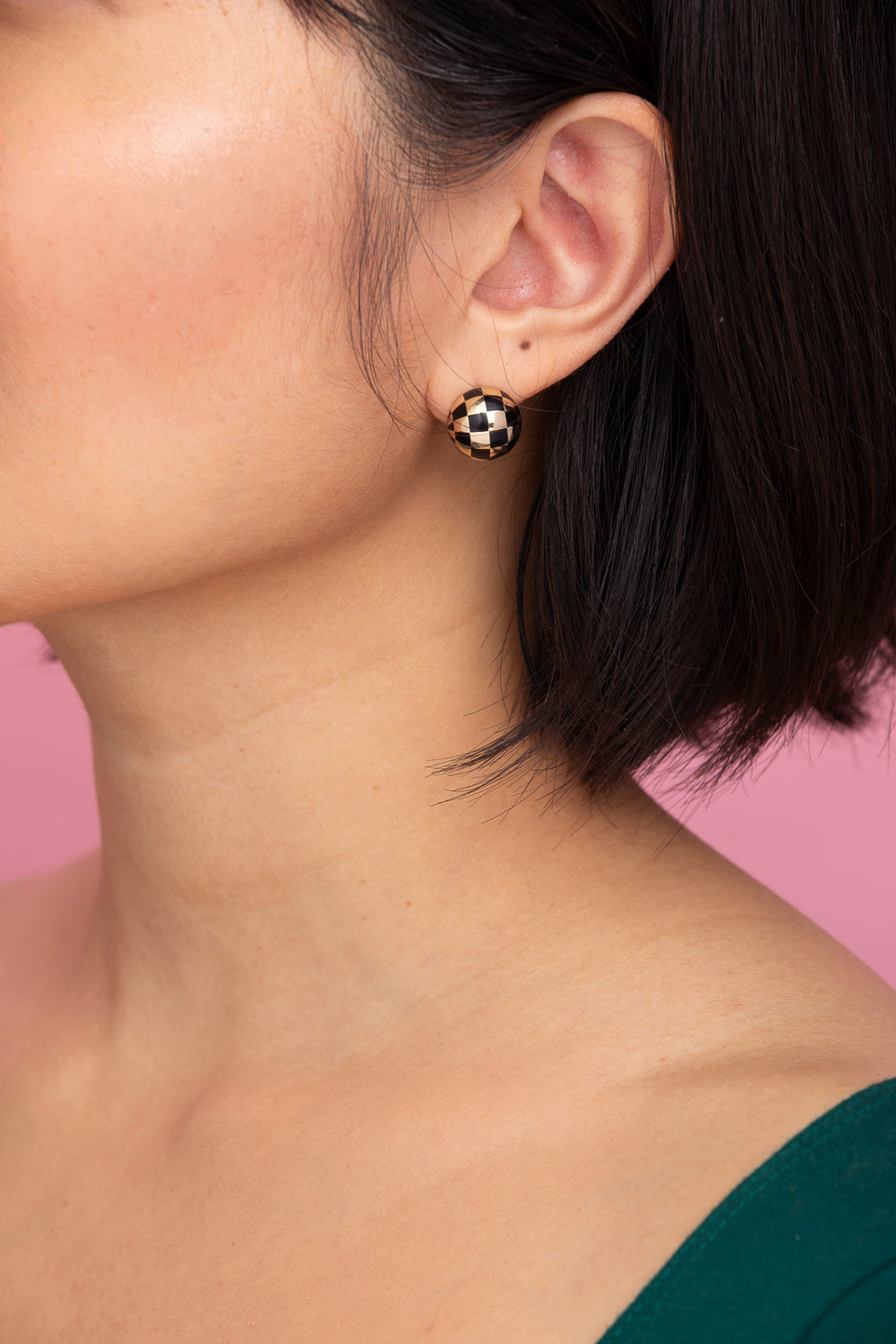Rachel Quinn Jewelry black and 14k yellow gold checkered ball earring pair on female model ear.