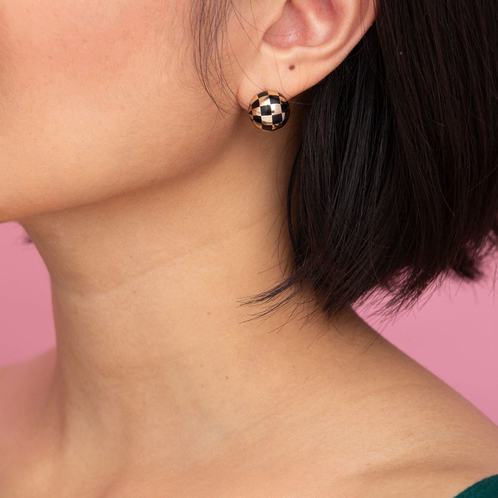Rachel Quinn Jewelry black and 14k yellow gold checkered ball earring pair on female model ear.