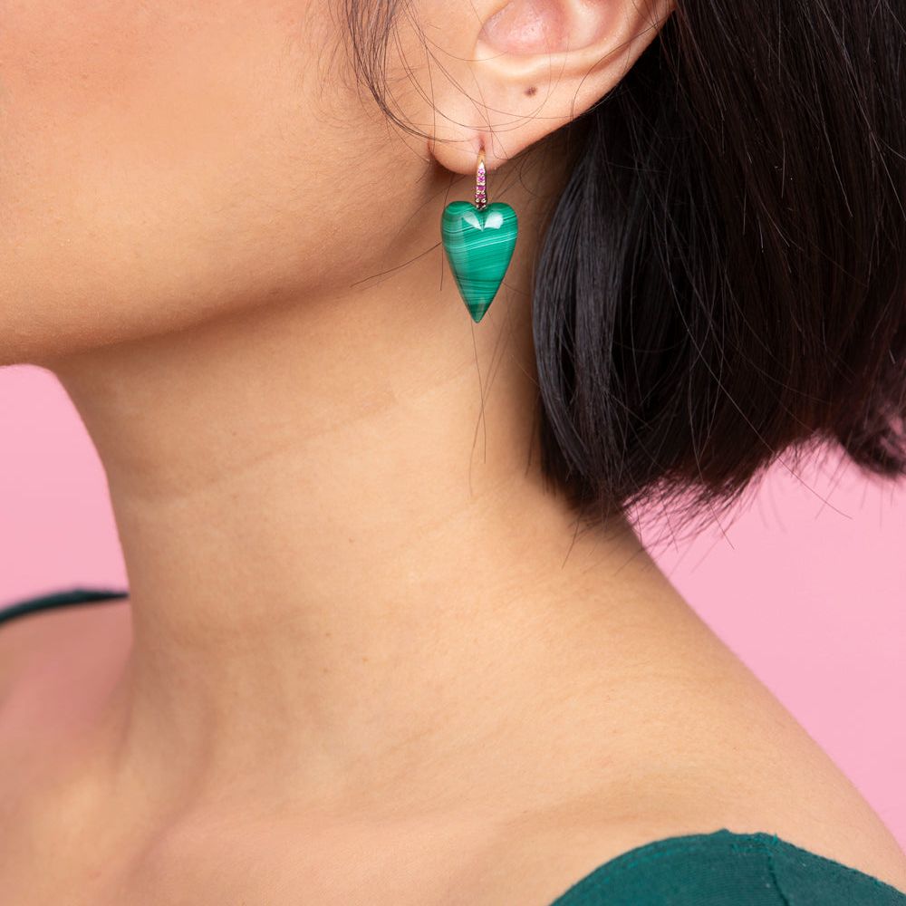 Rachel Quinn Jewelry malachite 3-dimensional heart earring pair magenta sapphires on earring hoop on female model ear.