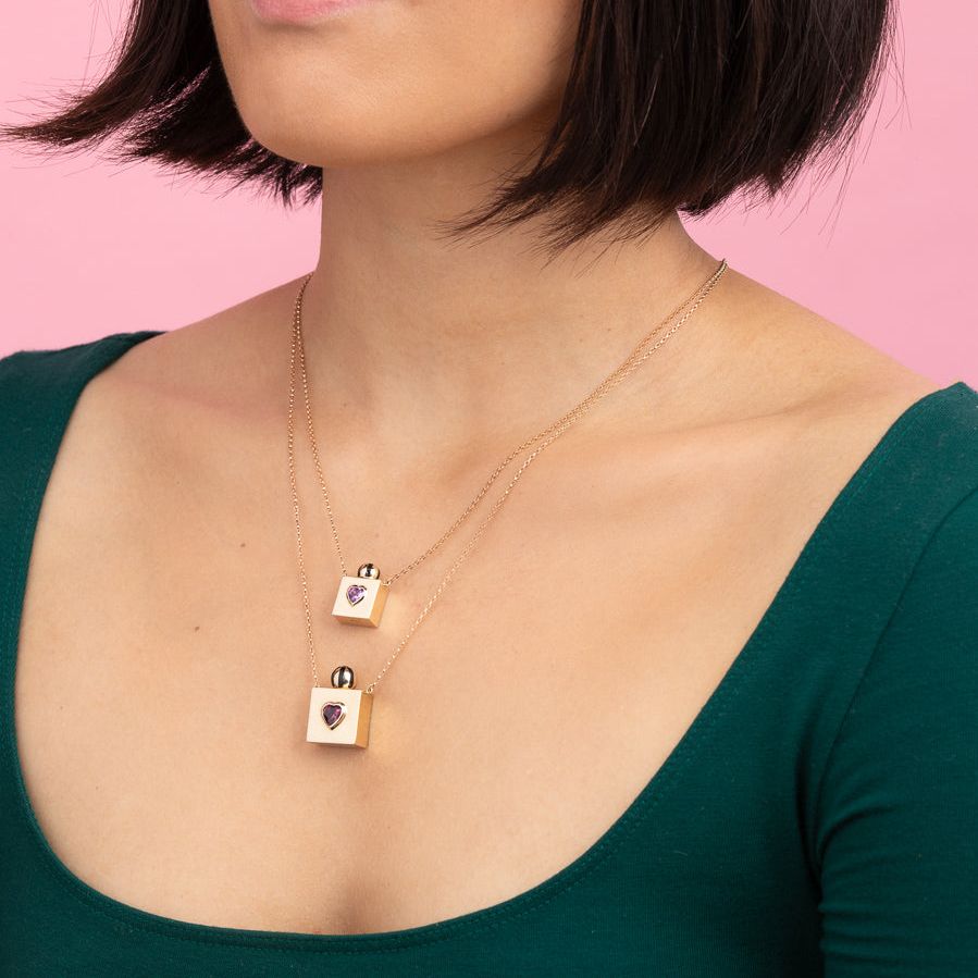 Rachel Quinn Jewelry small and large square 14k yellow gold vessel box necklaces on gold chain worn layered on female model neck.