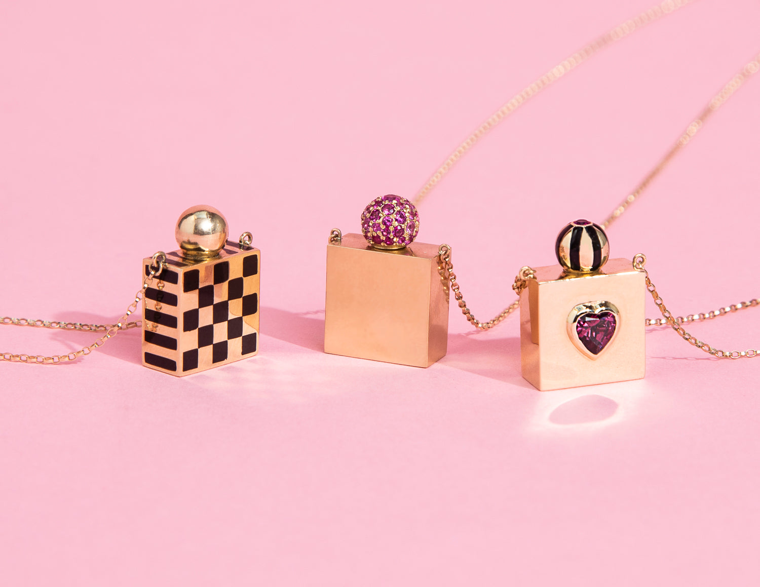 Rachel Quinn Jewelry 3 Square Vessel Box Necklaces in yellow gold variations on a pink background.