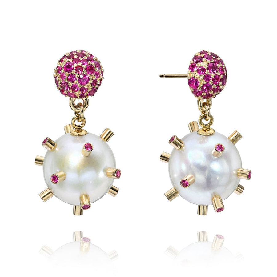 Rachel Quinn Jewelry pair of earrings with freshwater dangling pearls and 1.8ct magenta sapphire posts on white background.