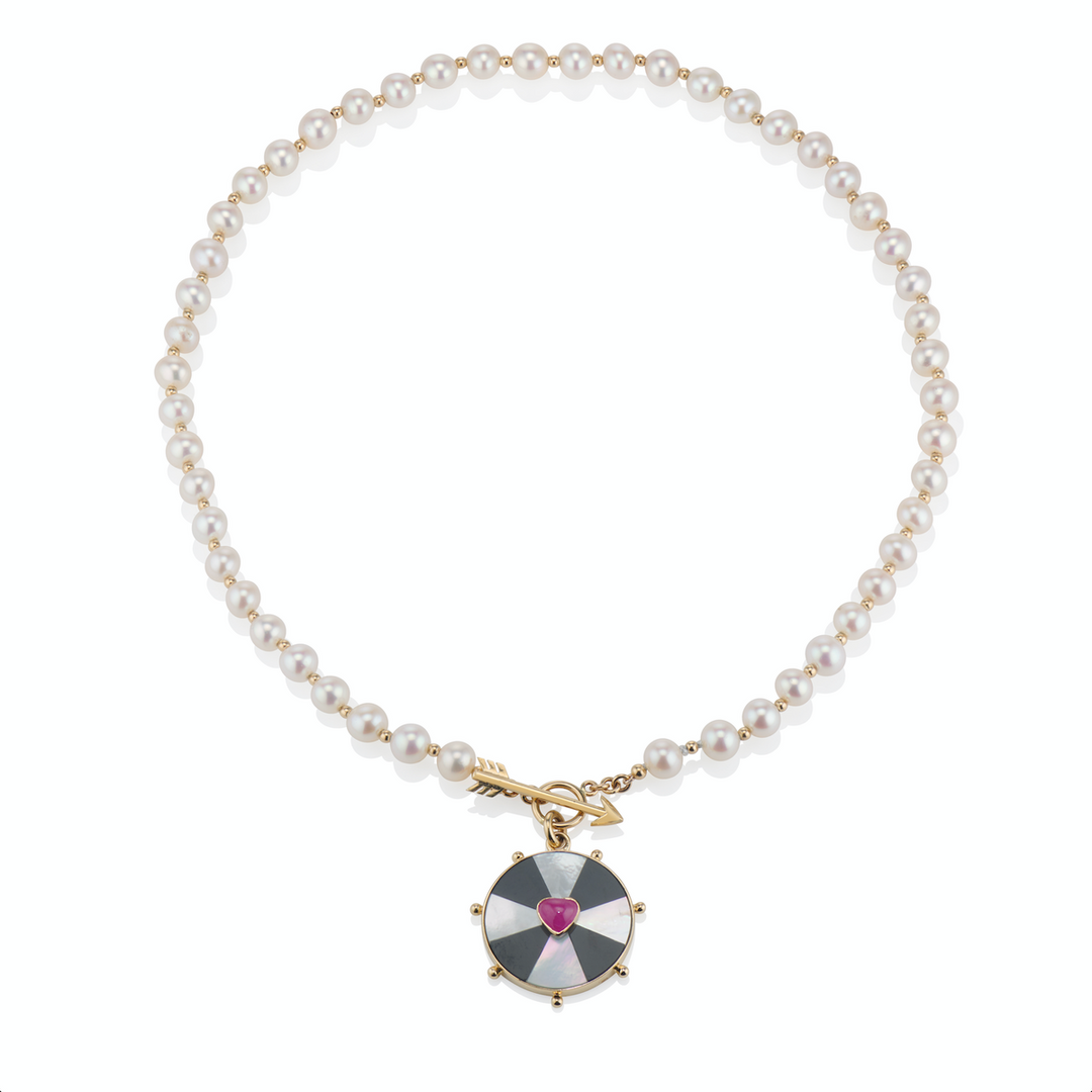 zoomed out view of the bullseye heart necklace on a white background