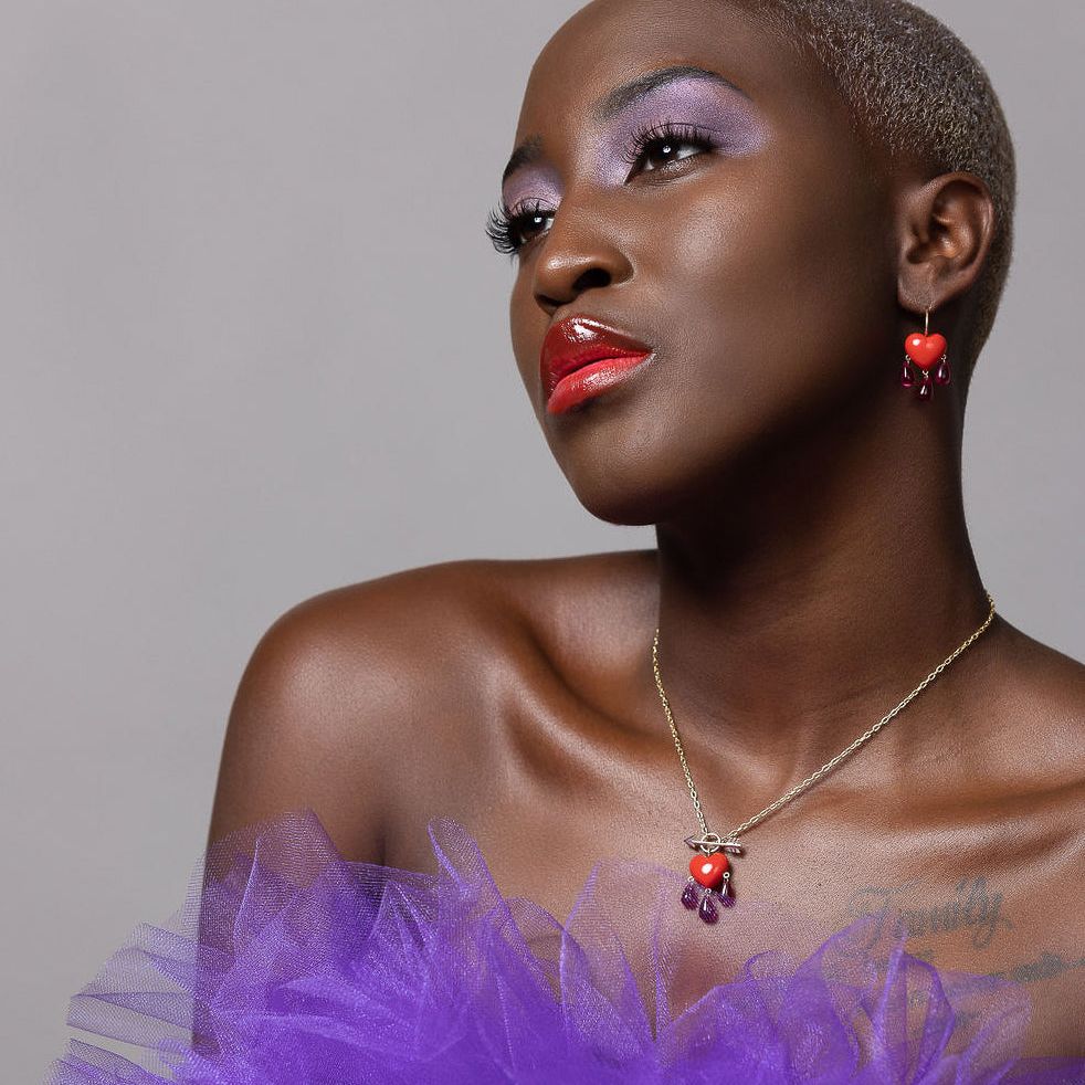 model wearing coral bleeding heart necklace and matching earrings