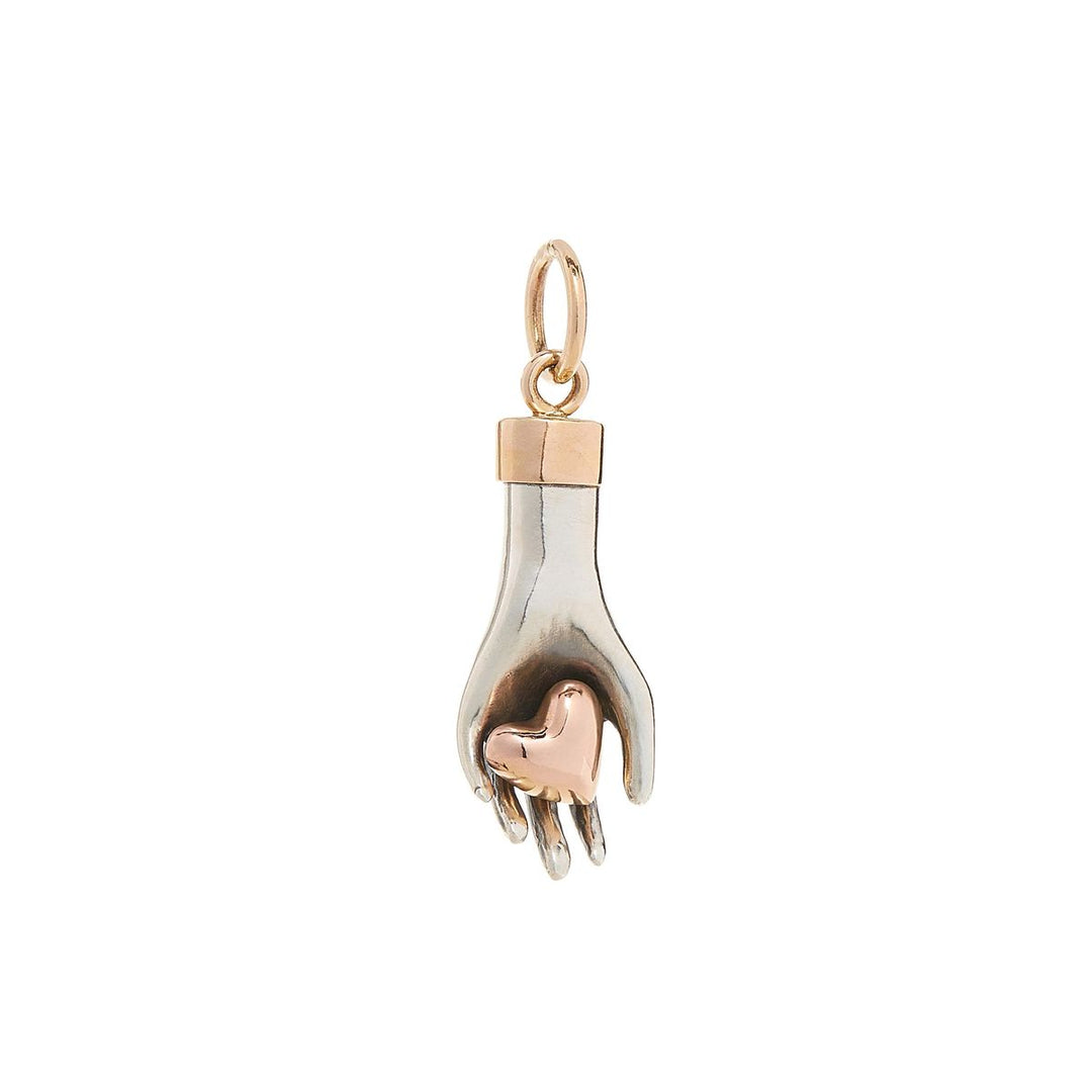 hand charm made of solid sterling silver gently holds a 14K rose gold heart with yellow gold wrist cuff and bail