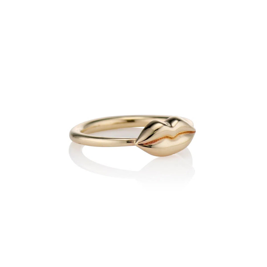 angeled shot of small gold lips on gold band on white background