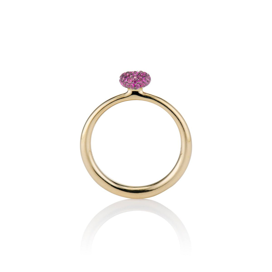 side shot of the sweet p heart ring ruby on a white background with a gold band