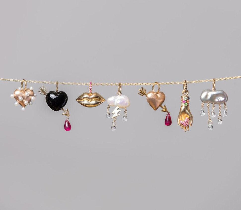 rachel quinn jewelry variations of different charms on a gold horiztonal chain