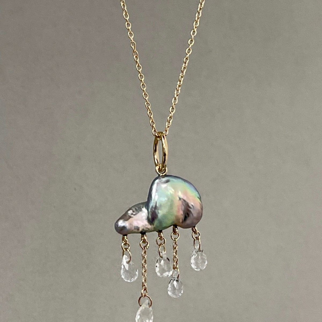 keshi pearl elongated puffy cloud shape charm with 5 small tear drop white topaz raining down underneath on yellow gold on a delicate yellow gold chain necklace