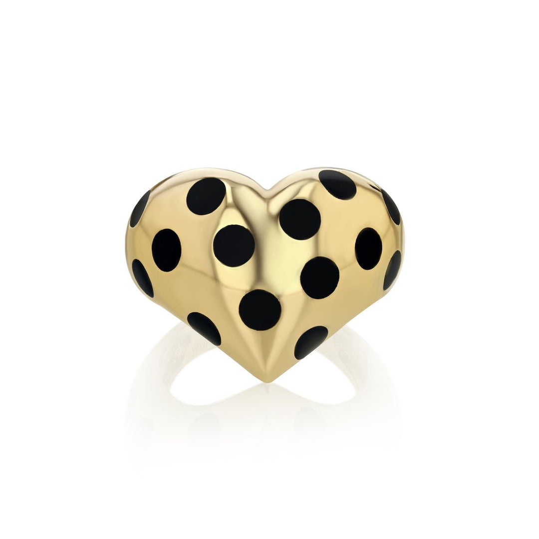 front view of gold chubby heart ring with black polka dots on a white background