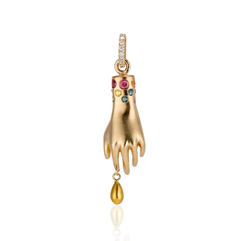 back view of hand charm with single diamond in the palm, solid gold drip from pointer finger, gemstones around the wrist and white diamonds on the bail