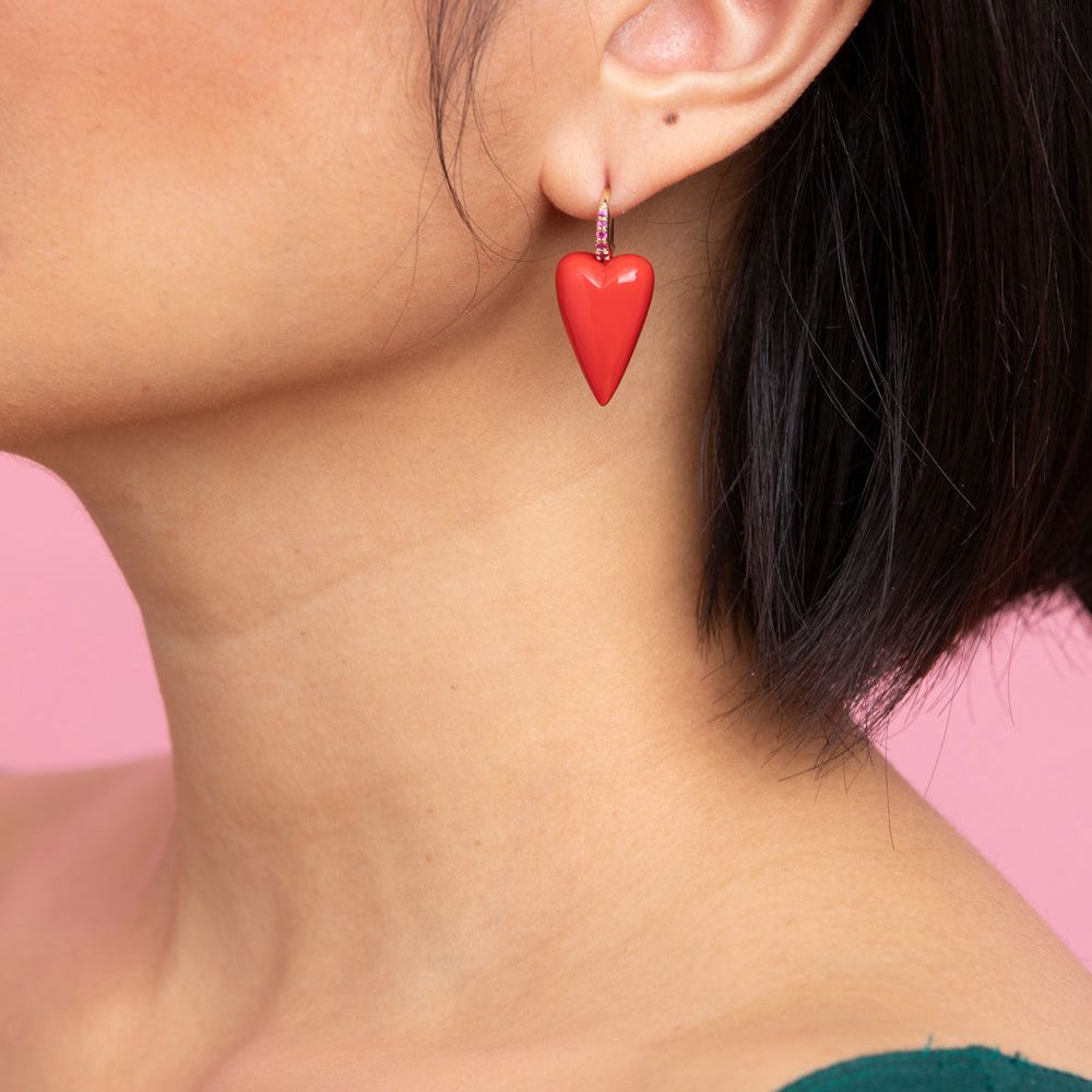 Rachel Quinn Jewelry coral 3-dimensional heart earring pair magenta sapphires on earring hoop on female model ear.