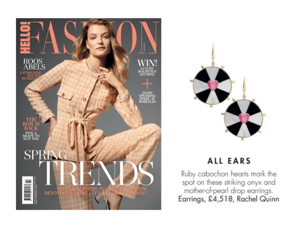 Hello! magazine feature of Rachel Quinn gold, mother-of-pearl-inlay, and ruby heart earrings alongside a woman in a peach and cream checkered pantsuit against a grey background.