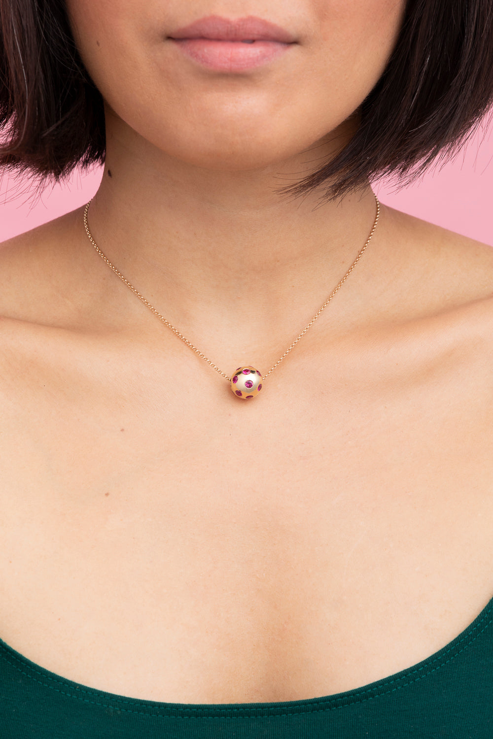 Rachel Quinn Jewelry Polka Dot Sphere Necklace magenta sapphires set all around on gold chain on female model neck