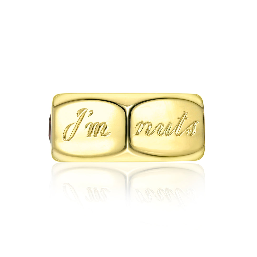 Gold charm with 'I'm nuts' engraving on a white background