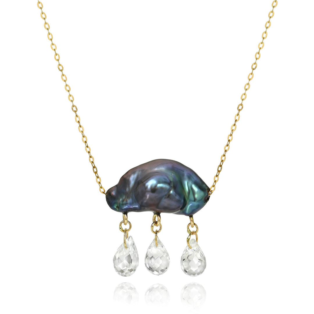 Necklace with a dark keshi pearl pendant and three smaller clear stone dangling below on a white background