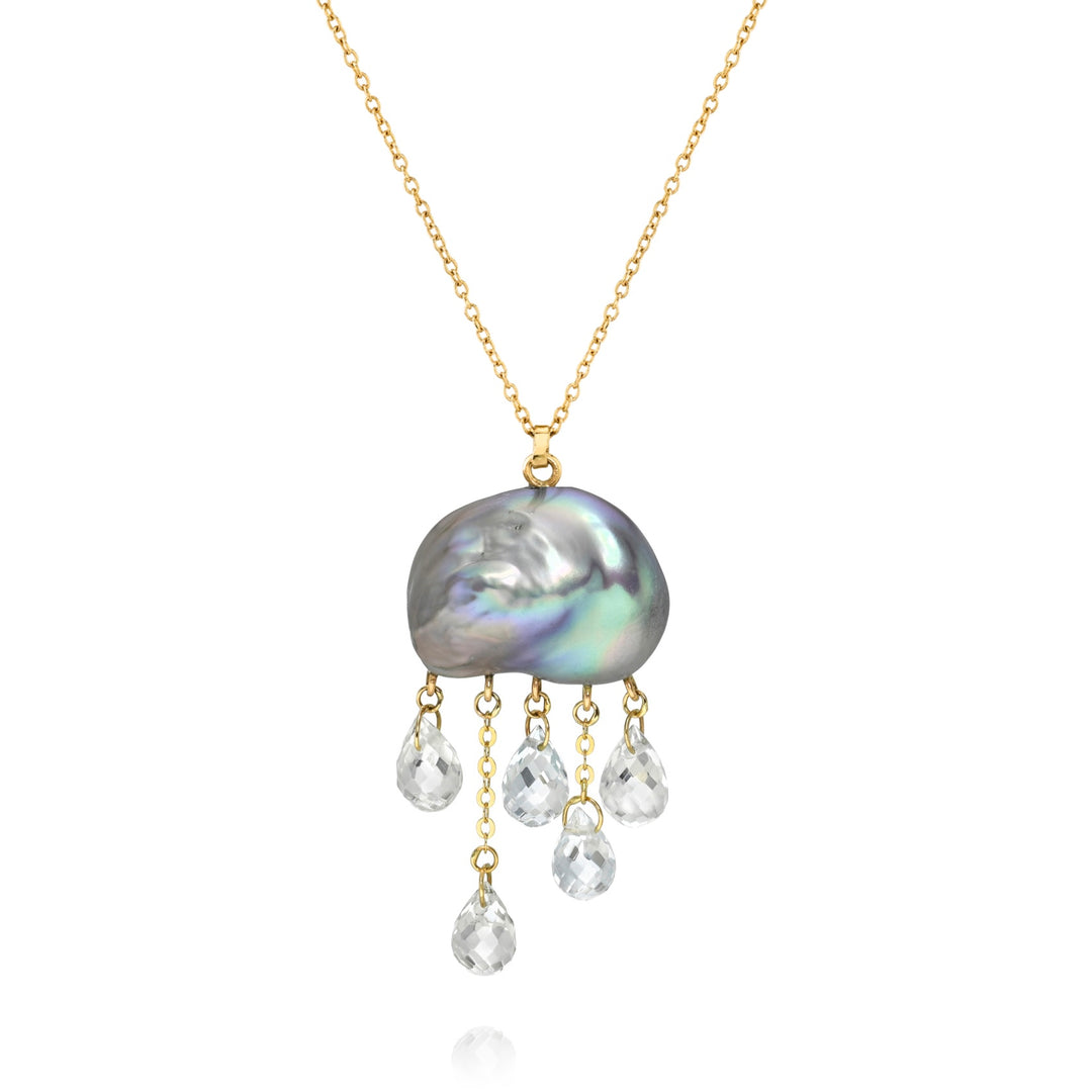 Grey keshi pearl pendant with dangling white topaz stones on a gold chain, white background.