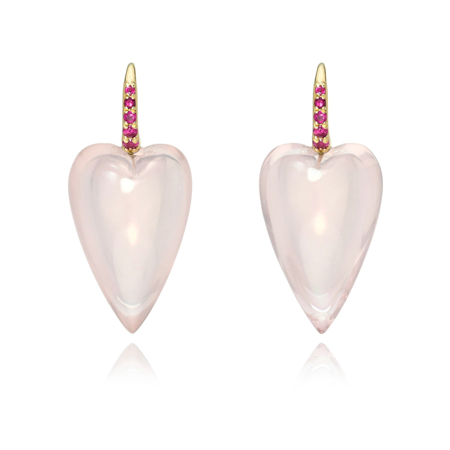 A pair of elongated heart earrings in pale pink rose by Rachel Quinn accented by pink sapphires in the gold ear wires, shown on a white background with a soft reflection.