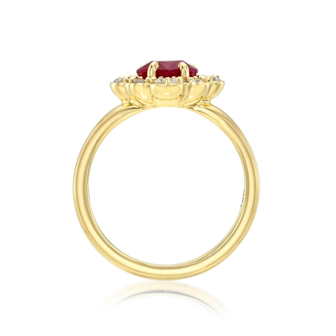 Side view of a gold ring with a ruby and diamonds on a white background
