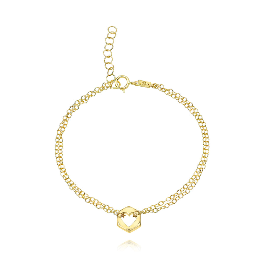 Gold bracelet with a hex nut charm with a heart cut in the center on a white background