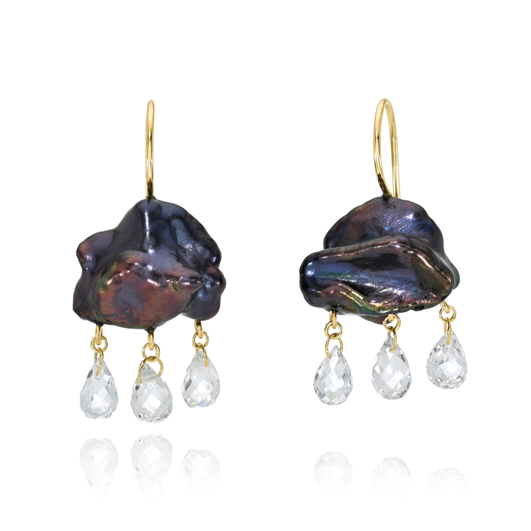 Pair of dark blue keshi pearl earrings with gold hooks and clear teardrop briolettes on a white background.