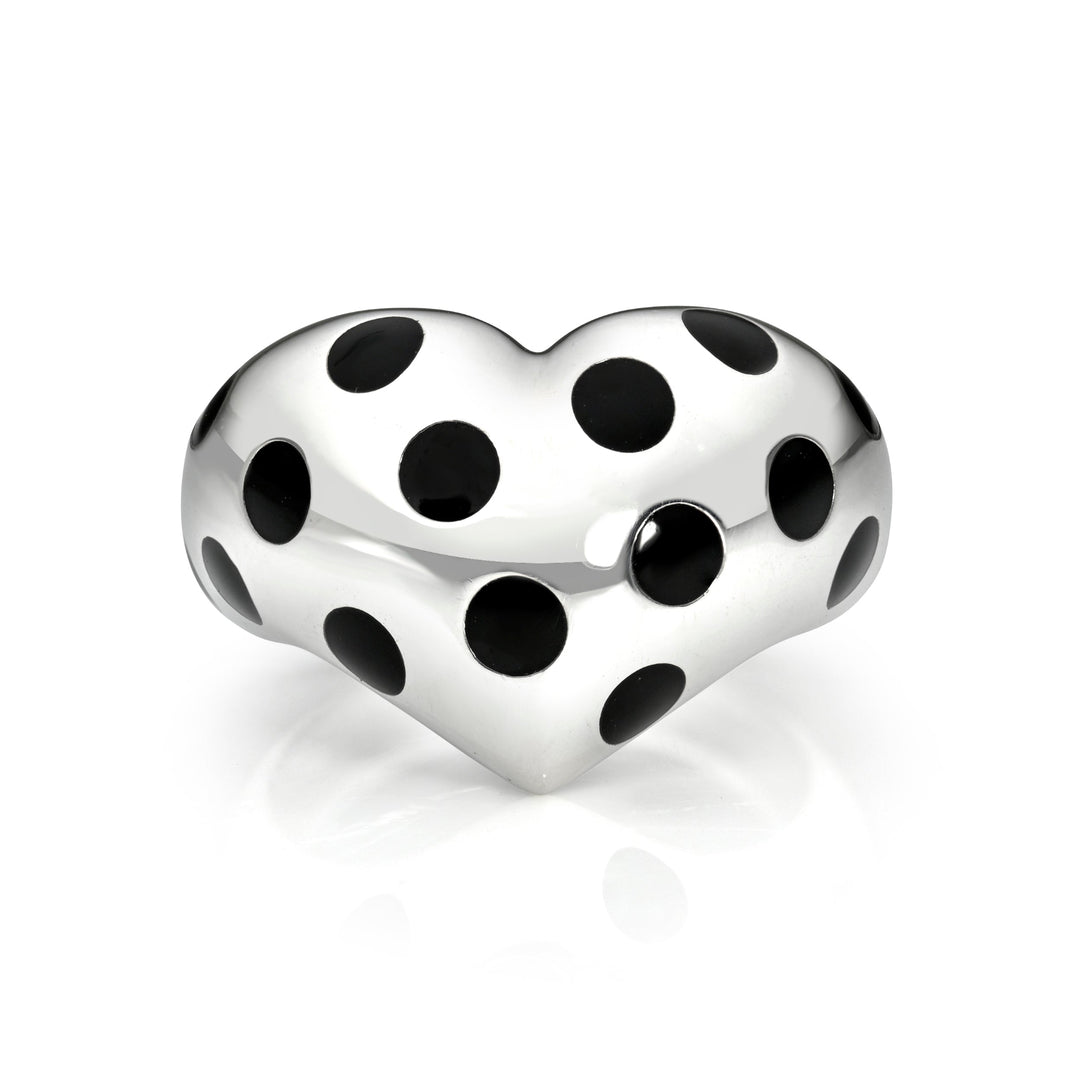 Silver heart ring with black polka dots against a white background