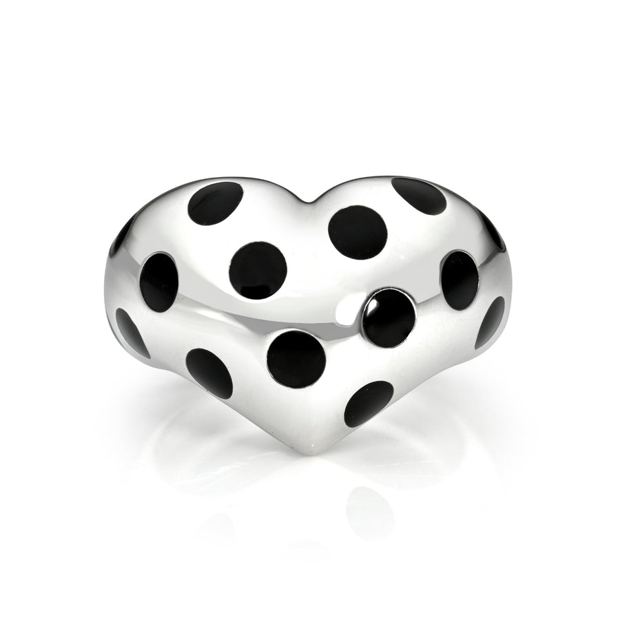 Silver heart ring with black polka dots against a white background