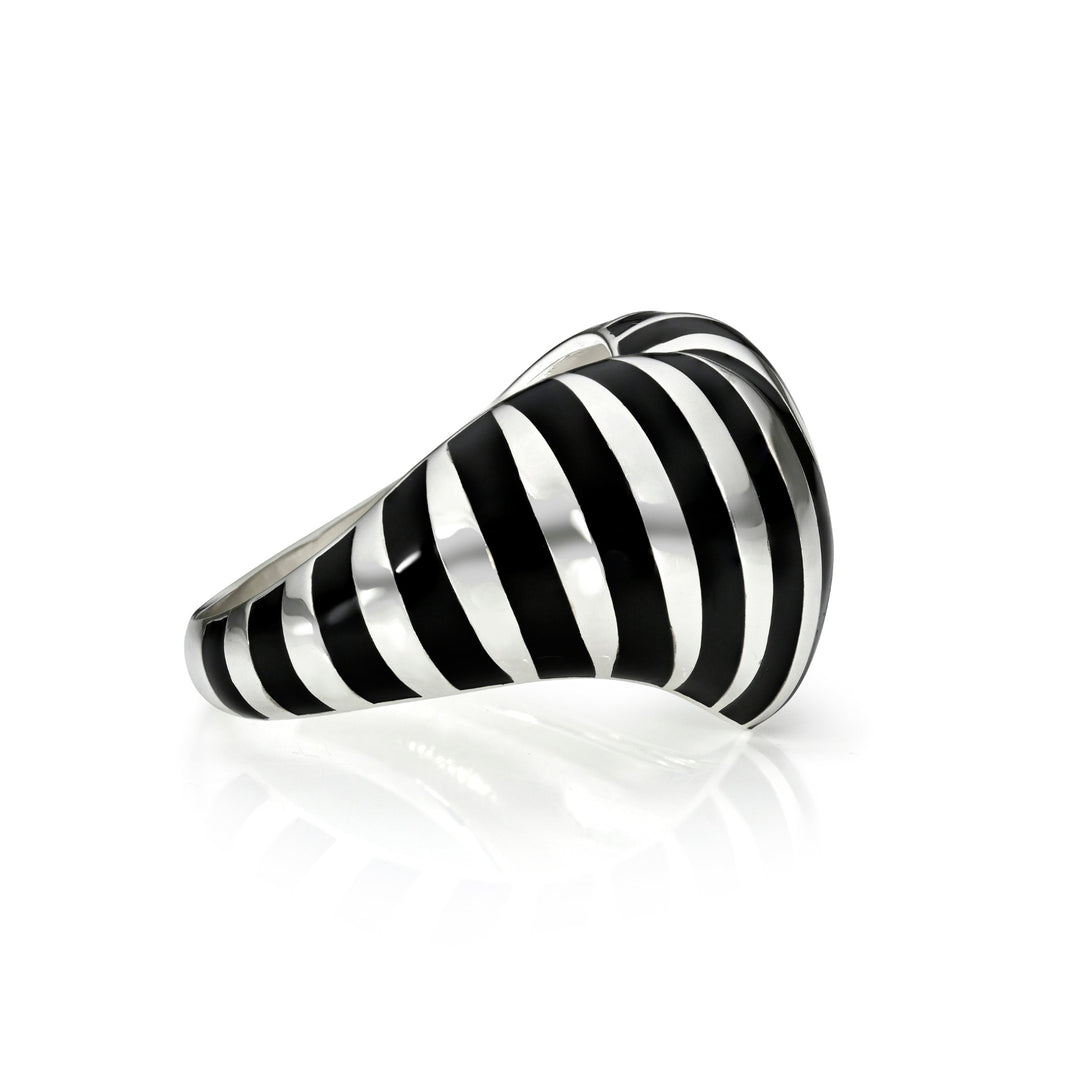 Side view of silver and black striped heart ring against a white background