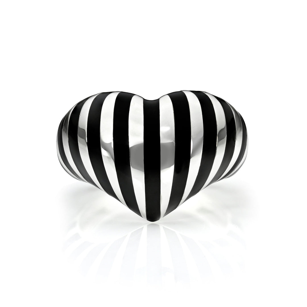 Silver heart ring with black stripes against  a white background