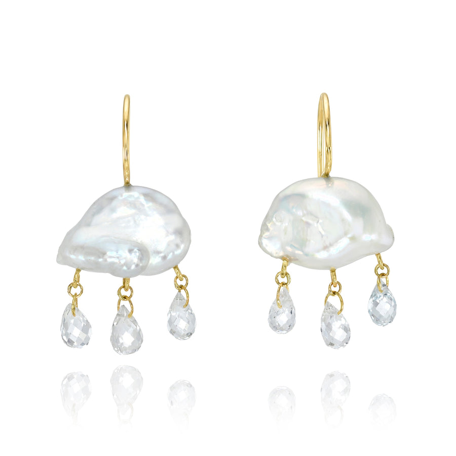 White keshi pearl earrings on delicate gold ear wires with clear gemstone briolettes dangling below against a white background.