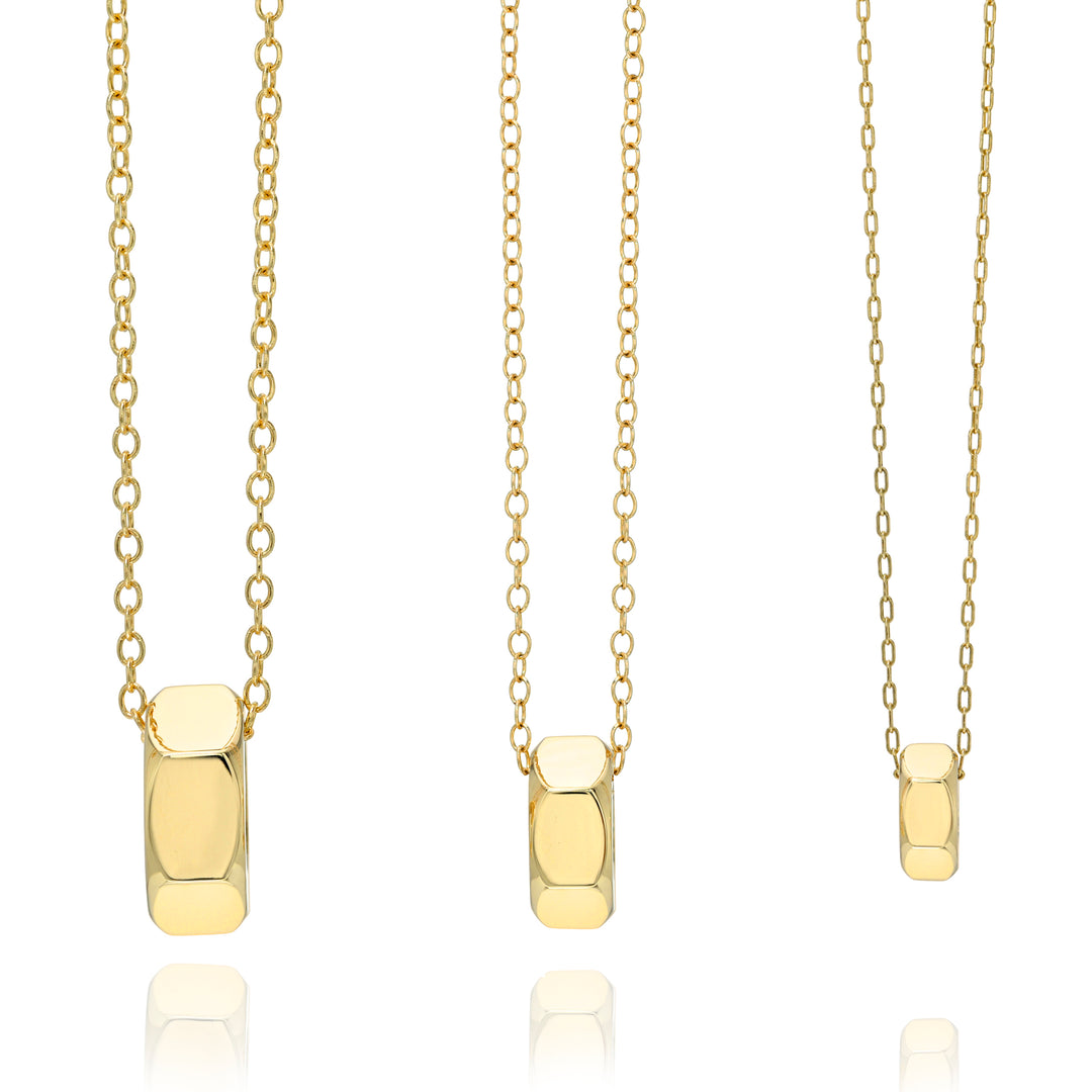 Three gold chain necklaces in three sizes with hex nut pendants on a white background