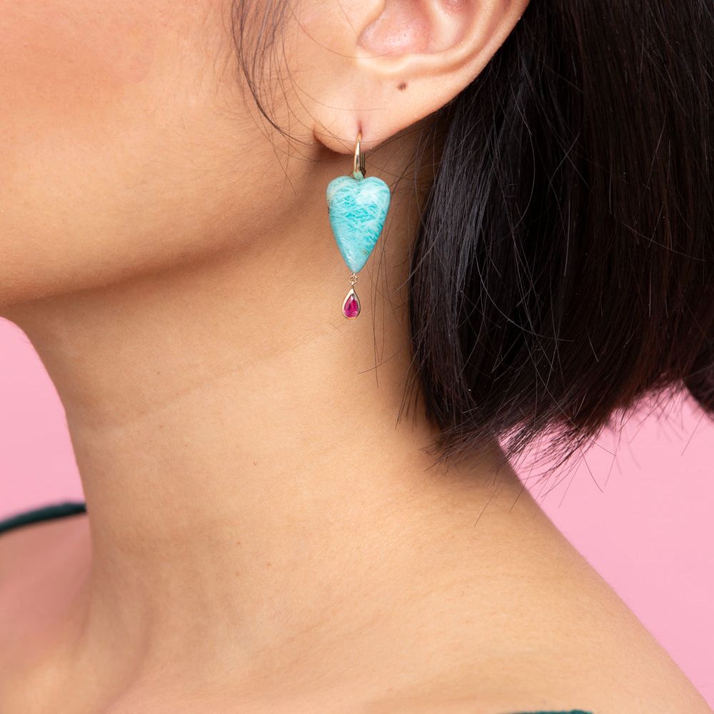 Rachel Quinn Jewelry hand-carved amazonite heart earring topped with 14K yellow ear wires with a bezel-set ruby droplet on female model ear