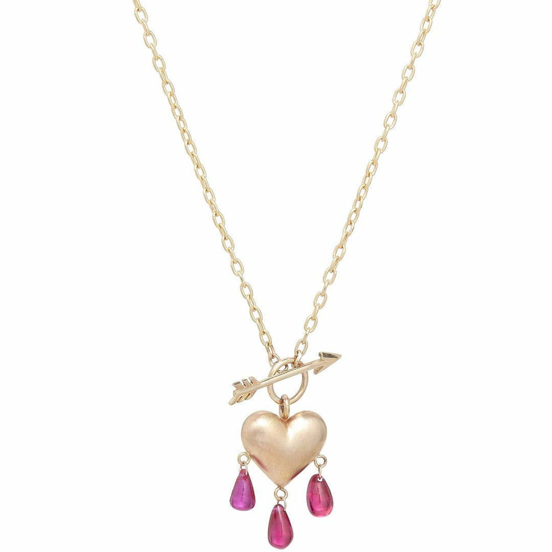 Yellow gold puffy heart on elongated link chain with arrow in front and pink ruby droplets