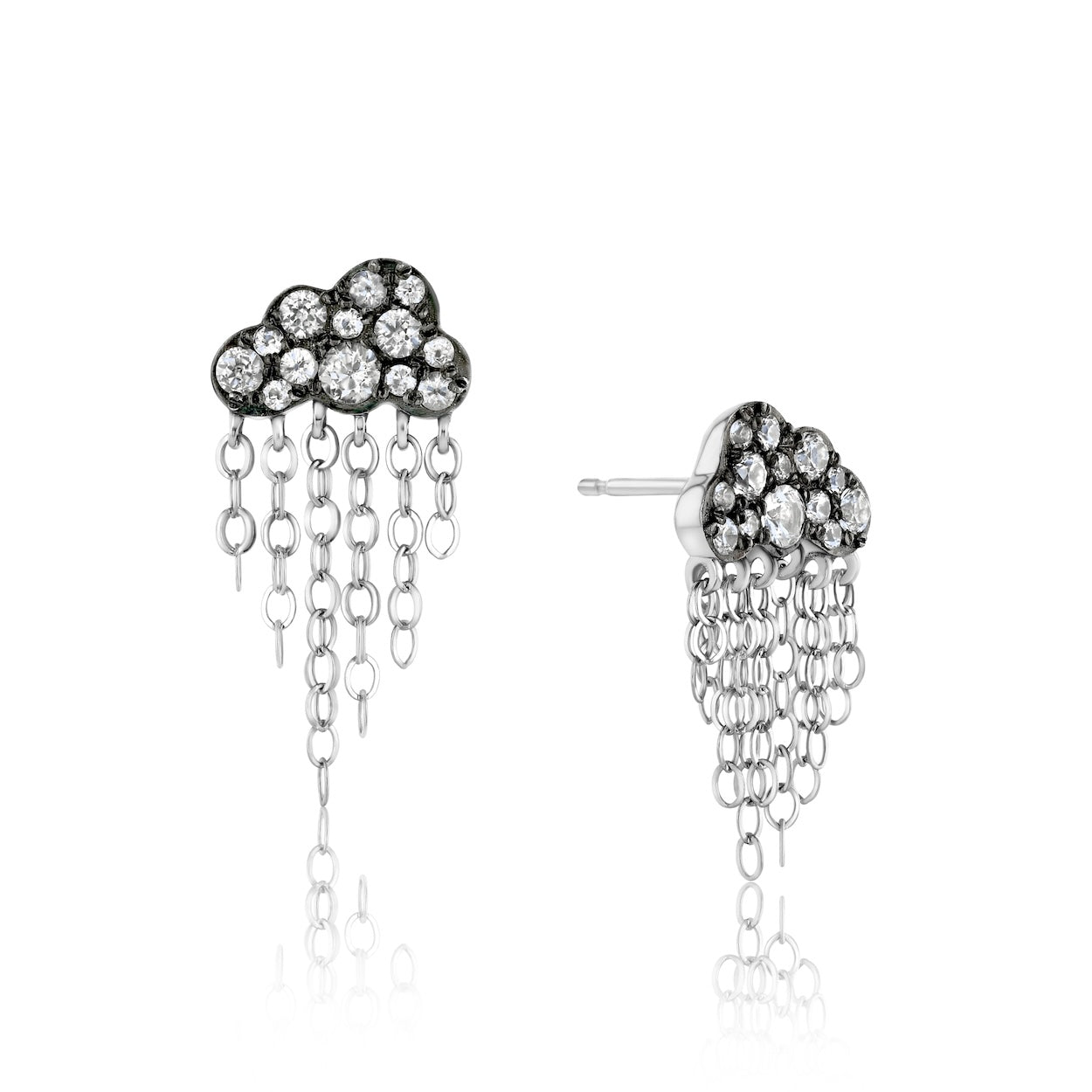 Darkened white gold cloud earrings with white gemstones and dangling chain strands against a white background.
