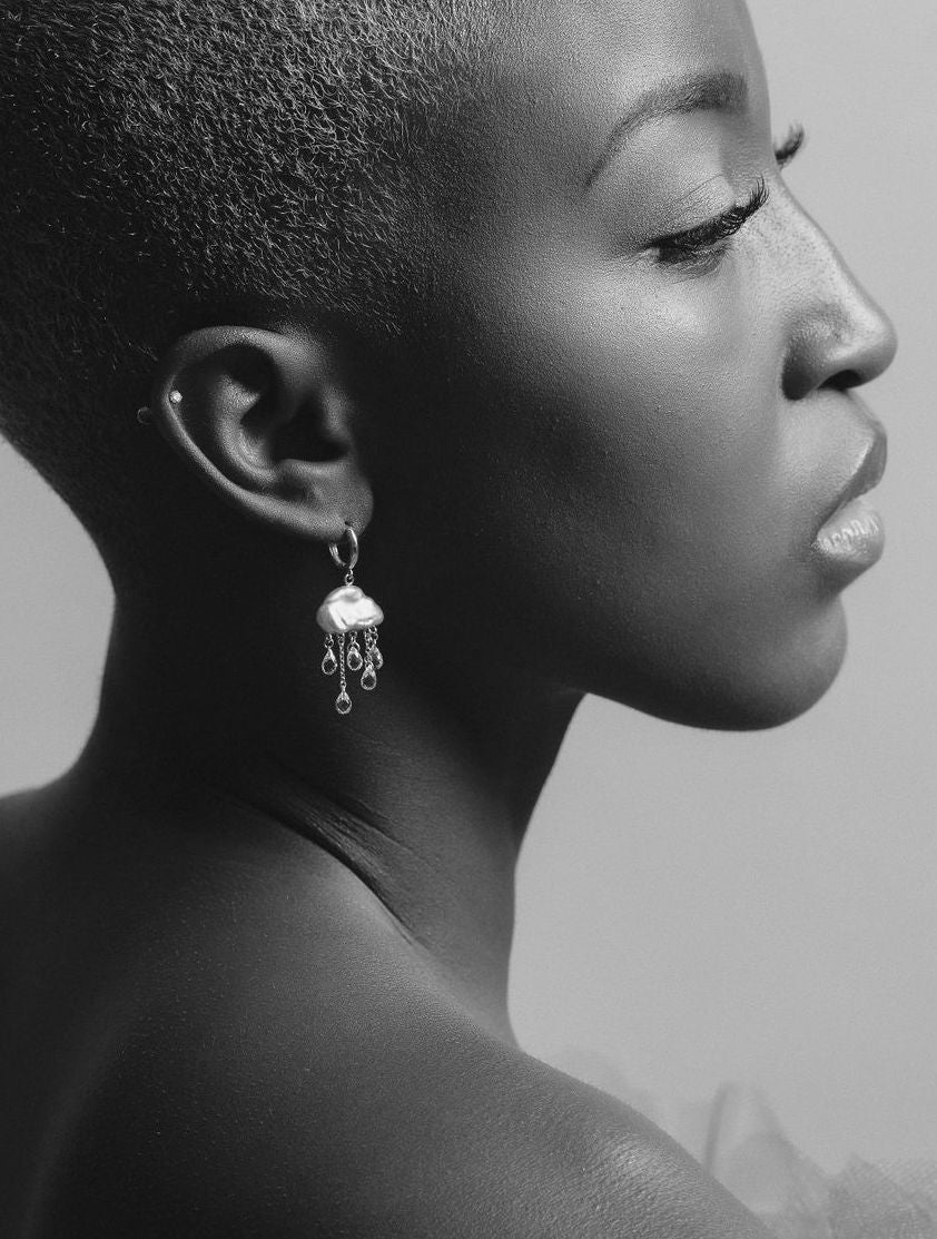 Black and white photo of a profile showing the pearl cloud hoops with stone rain drops cascading below