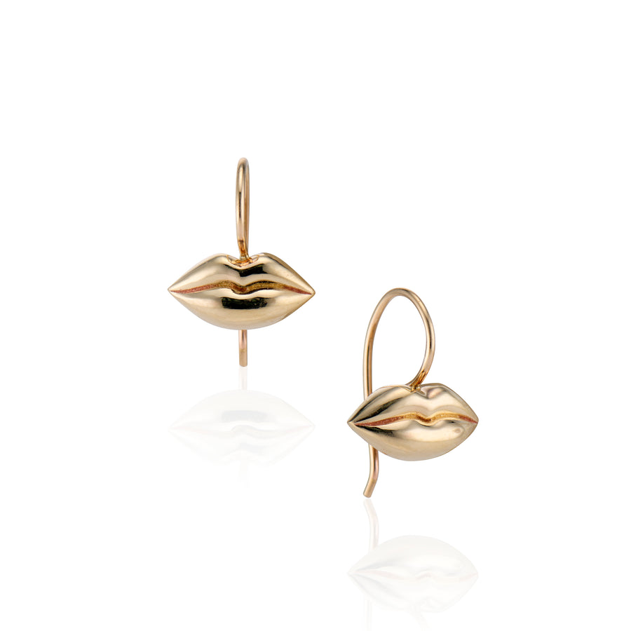 small gold lip earrings on gold hooks on white background