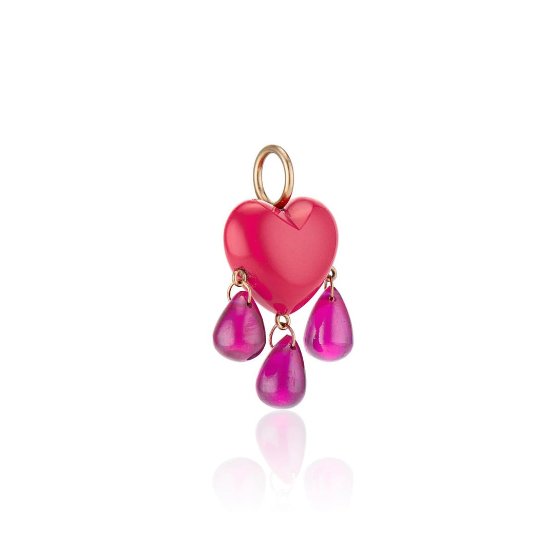 angled view of small smooth coral heart charm drips with a trio of ruby blood with yellow gold