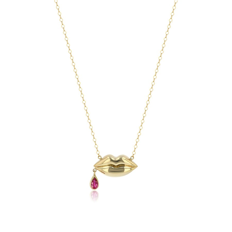 yellow gold lips pendant on gold chain with single drop of ruby blood dangling from corner of the mouth
