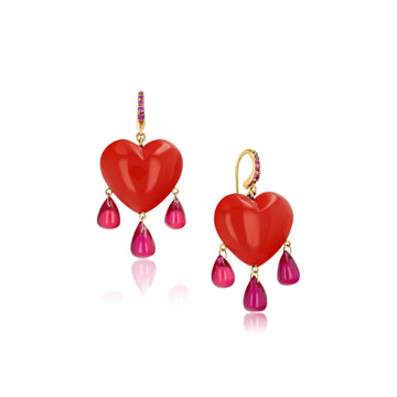 coral heart earrings with three rubies dangling and rubies in gold earring hook on a white background