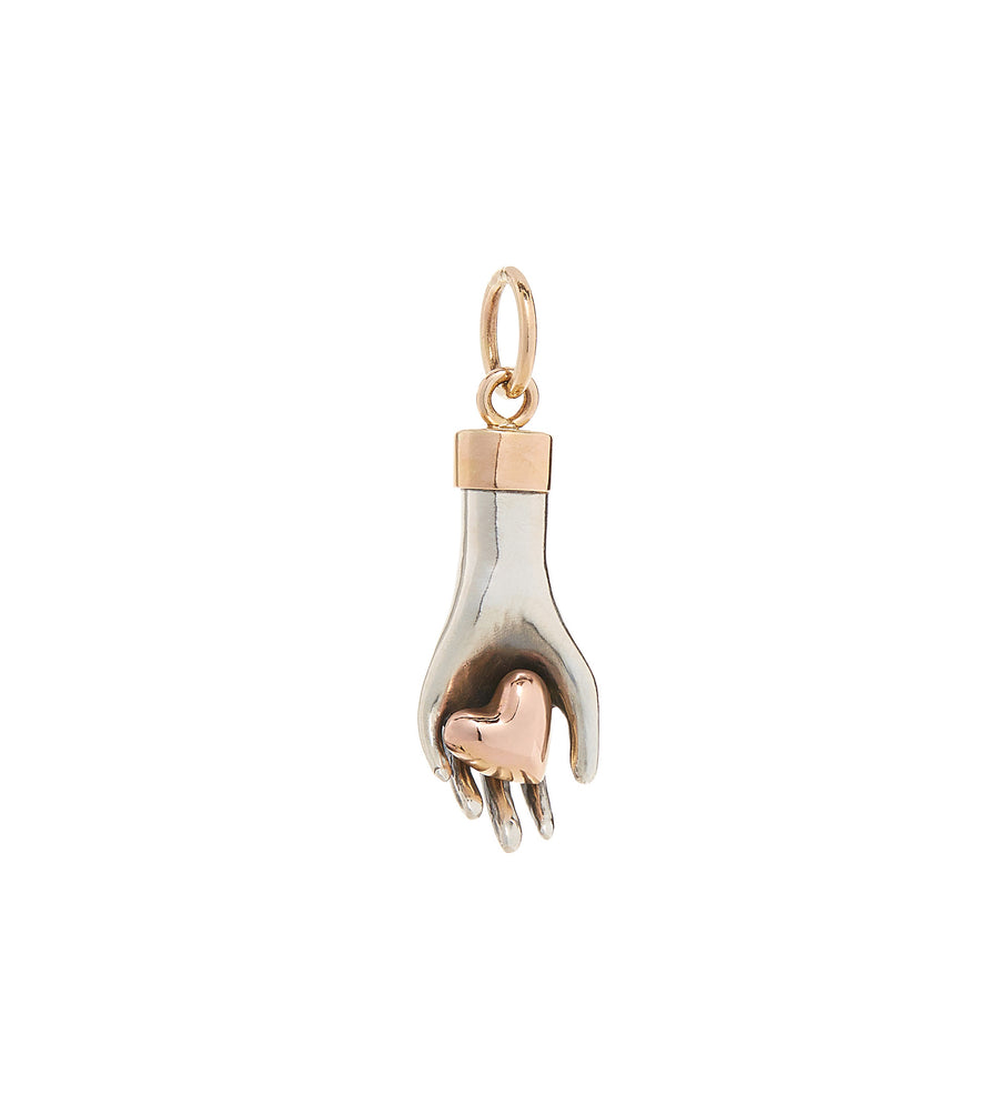hand charm made of solid sterling silver gently holds a 14K rose gold heart with yellow gold wrist cuff and bail