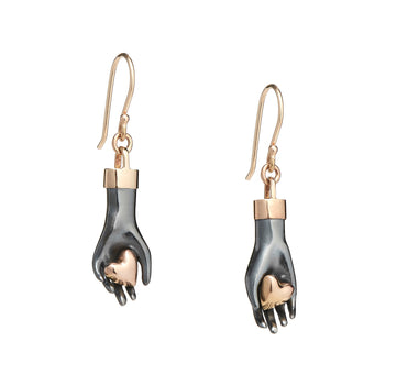 Sterling silver hand earrings gently hold a pair of 14K solid rose gold hearts. Wrist cuff and ear wires are made of yellow gold