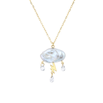White keshi pearl cloud electrified with a 14K yellow gold lightning bolt as a trio of white topaz rain down on gold chain necklace