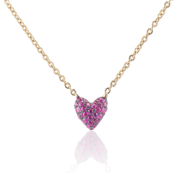 zoomed in shot of the sweet p heart necklace ruby on a white background with a gold chain