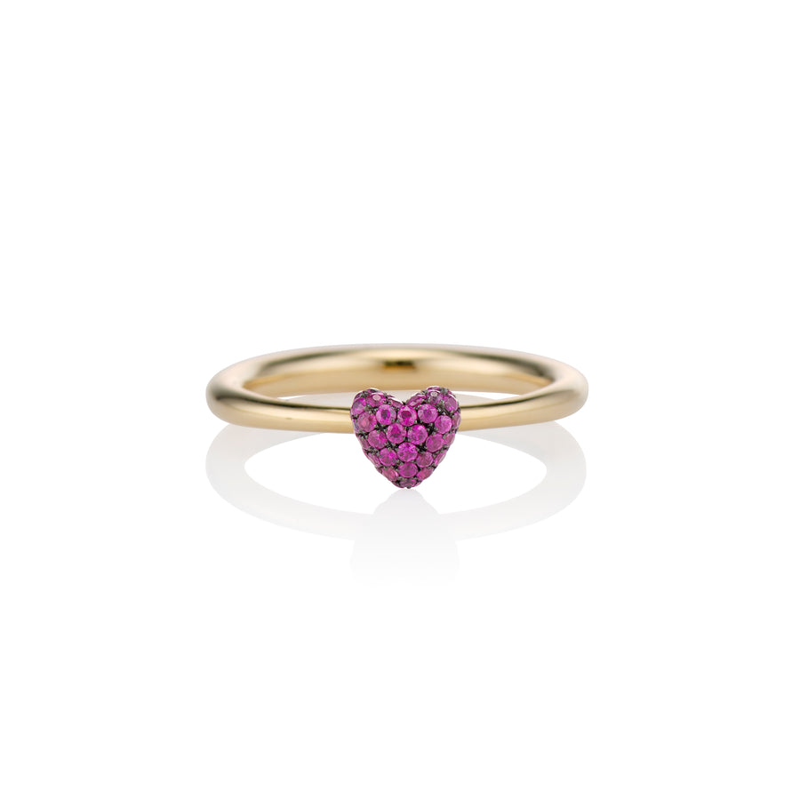 zoomed in shot of the sweet p heart ring ruby on a white background with a gold band