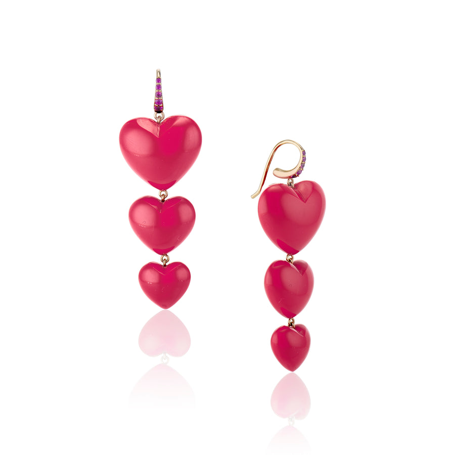 three coral hearts cascading down per earring with rubies on gold hook posts on a white background