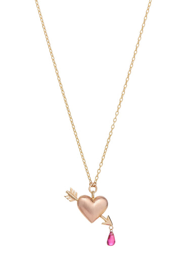 small rose gold puffed heart pendant on yellow gold chain with yellow gold arrow piercing the heart with a single ruby dripping from tip of arrow